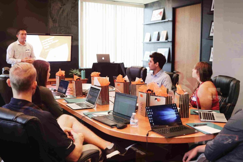 employees sit around a desk in an hr tech office