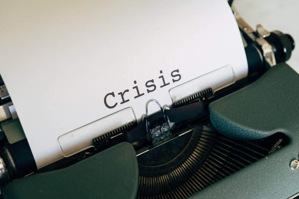 the word crisis written on a paper
