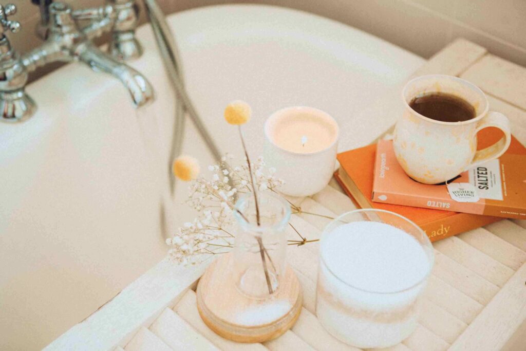 Self care products lay on bathtub